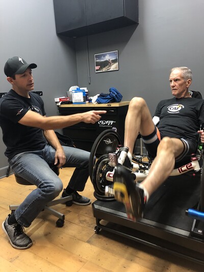 A specialized physical therapy performance coaching session with an athlete using adaptive cycling equipment at Define Wellness.